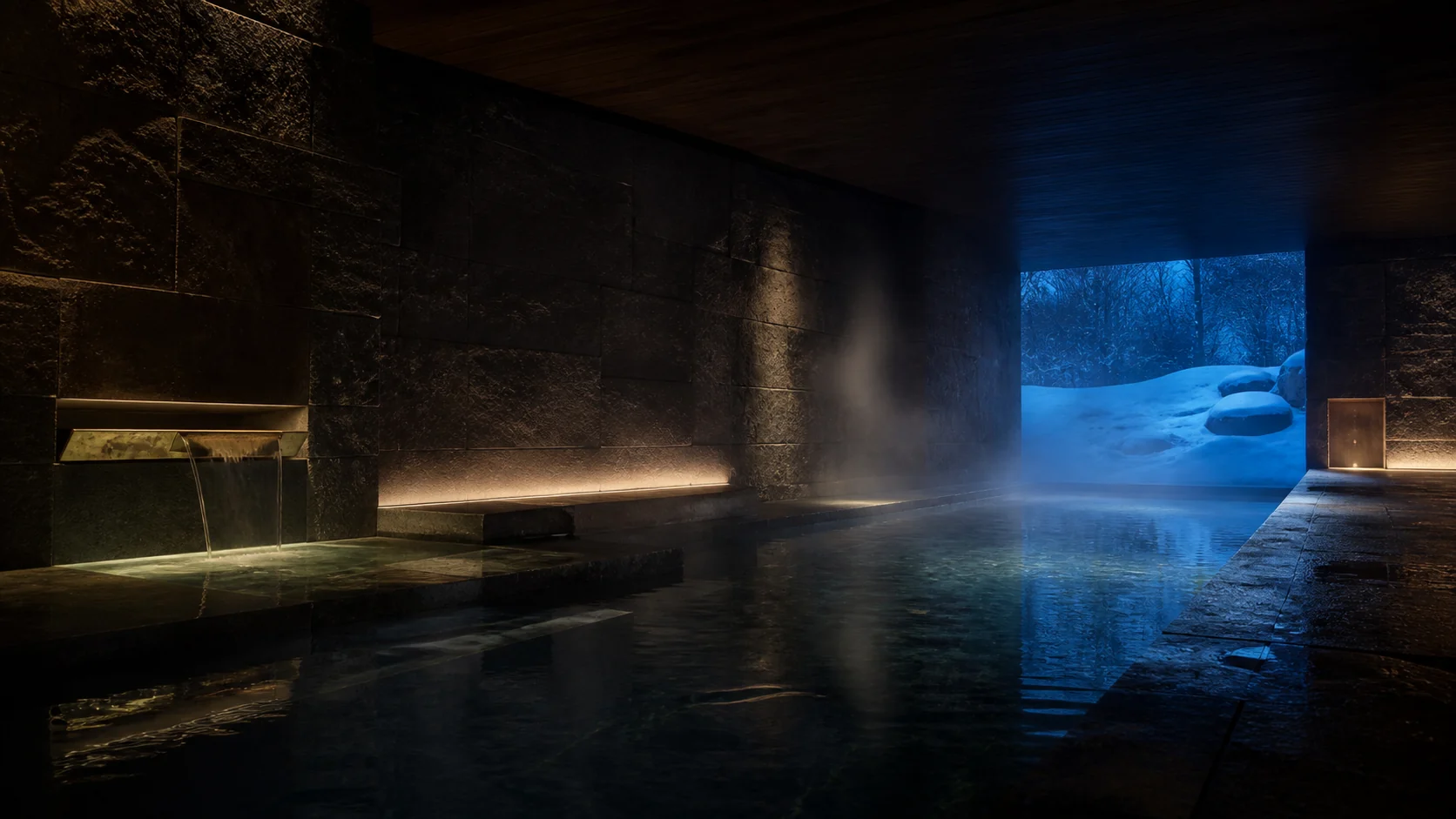 A steaming stone thermal pool surrounded by snow